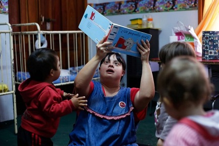 Noelia Garella (C), a kindergarten teacher born with Down Syndrome, reads a book to children at the Jeromito kindergarten in Cordoba, Argentina on September 29, 2016. When Noelia Garella was a child, a nursery school rejected her as a "monster." Now 31, she is in a class of her own. In the face of prejudice, she is the first person with Down syndrome to work as a kindergarten teacher in Argentina -- and one of few in the world. / AFP PHOTO / DIEGO LIMADIEGO LIMA/AFP/Getty Images